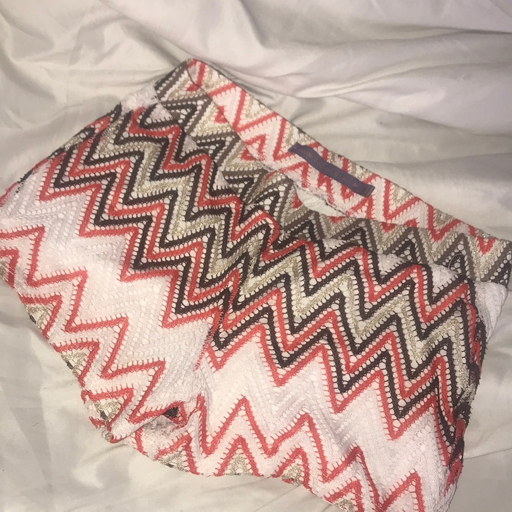 White pink gold and brown designed shorts.